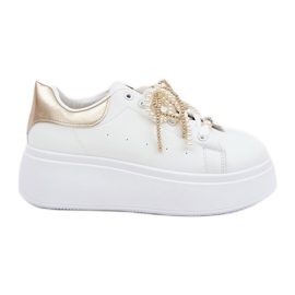Sneaker femminili sulla piattaforma con decorazioni bianche e oro bianco