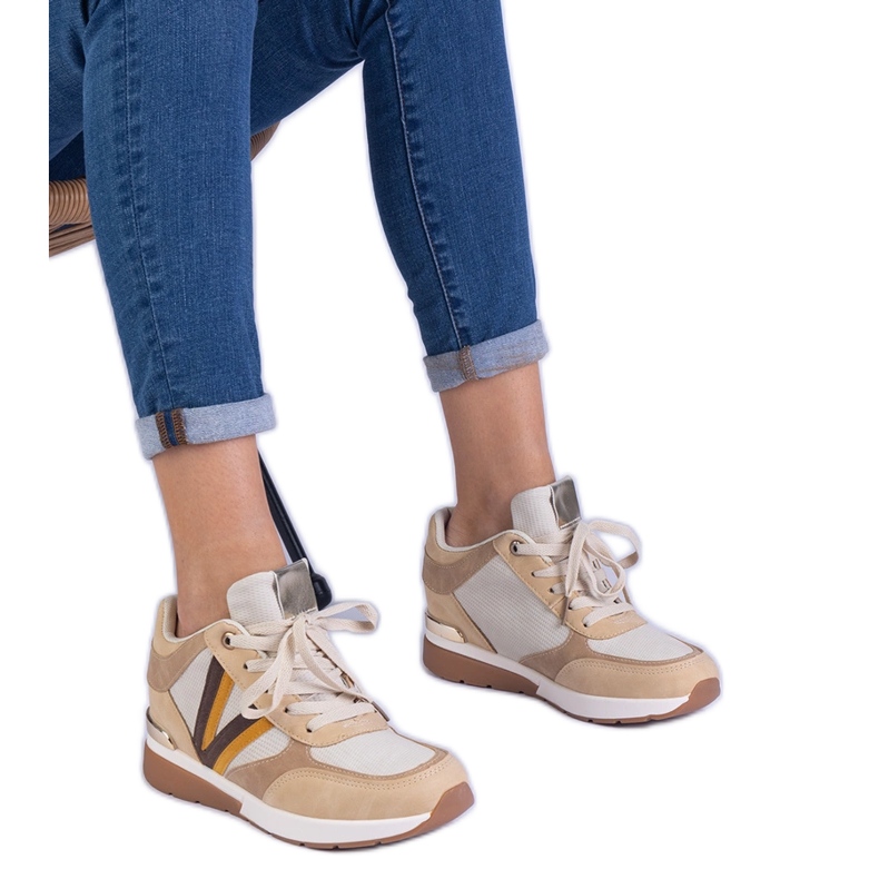 Sneaker da donna marrone su un cuneo nascosto