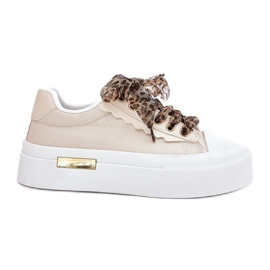 Sneaker femminili su una piattaforma enorme con beige di allacciatura decorativa