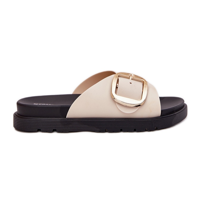 Le pantofole da donna sulla piattaforma con un beige di morsetto d'oro
