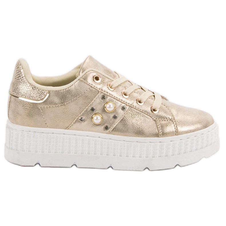 Calzature d'oro sulla piattaforma