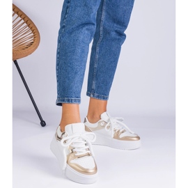 Sneakers con plateau bianche e dorate d'oro 1