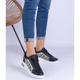 Sneaker da donna nera su un cuneo nascosto nero 1