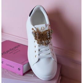 Sneaker in bianco e nero decorate con una farfalla con zirconi bianca 1