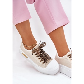 Sneaker femminili su una piattaforma enorme con beige di allacciatura decorativa 2