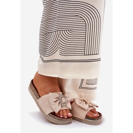 Infradito da donna sulla piattaforma con un arco e una spilla decorativa beige 1
