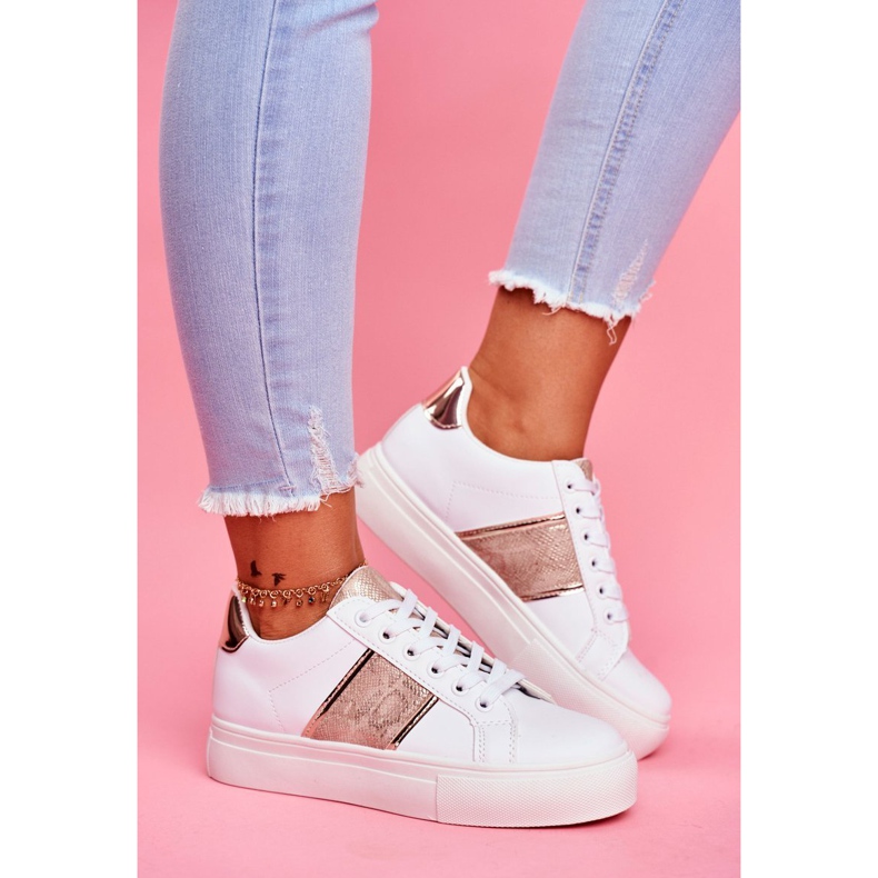 Le scarpe sportive da donna bianche e dorate continuano ad andare avanti bianco 1