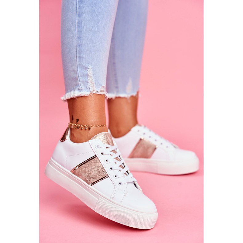 Le scarpe sportive da donna bianche e dorate continuano ad andare avanti bianco 2